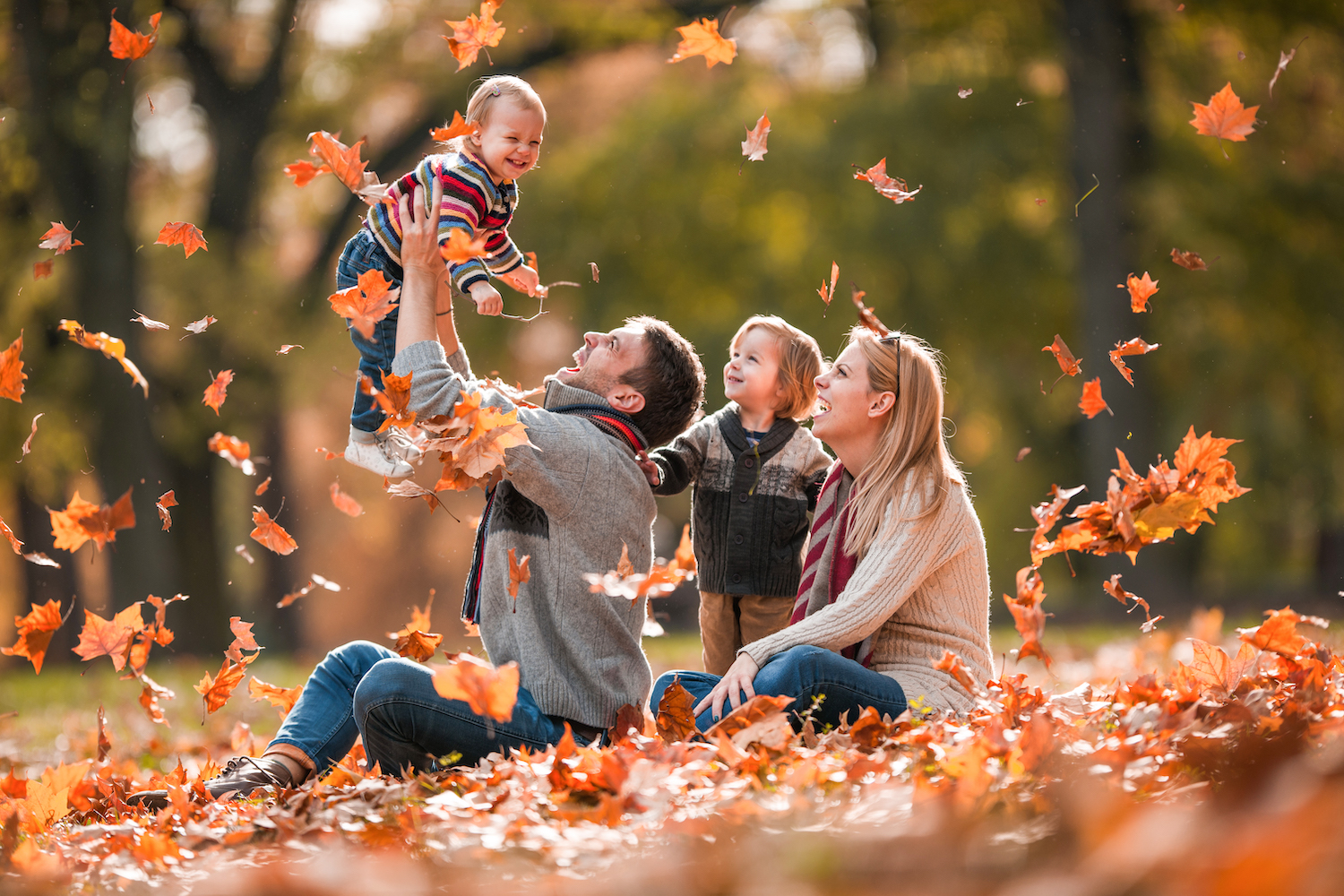 family in fall leaves